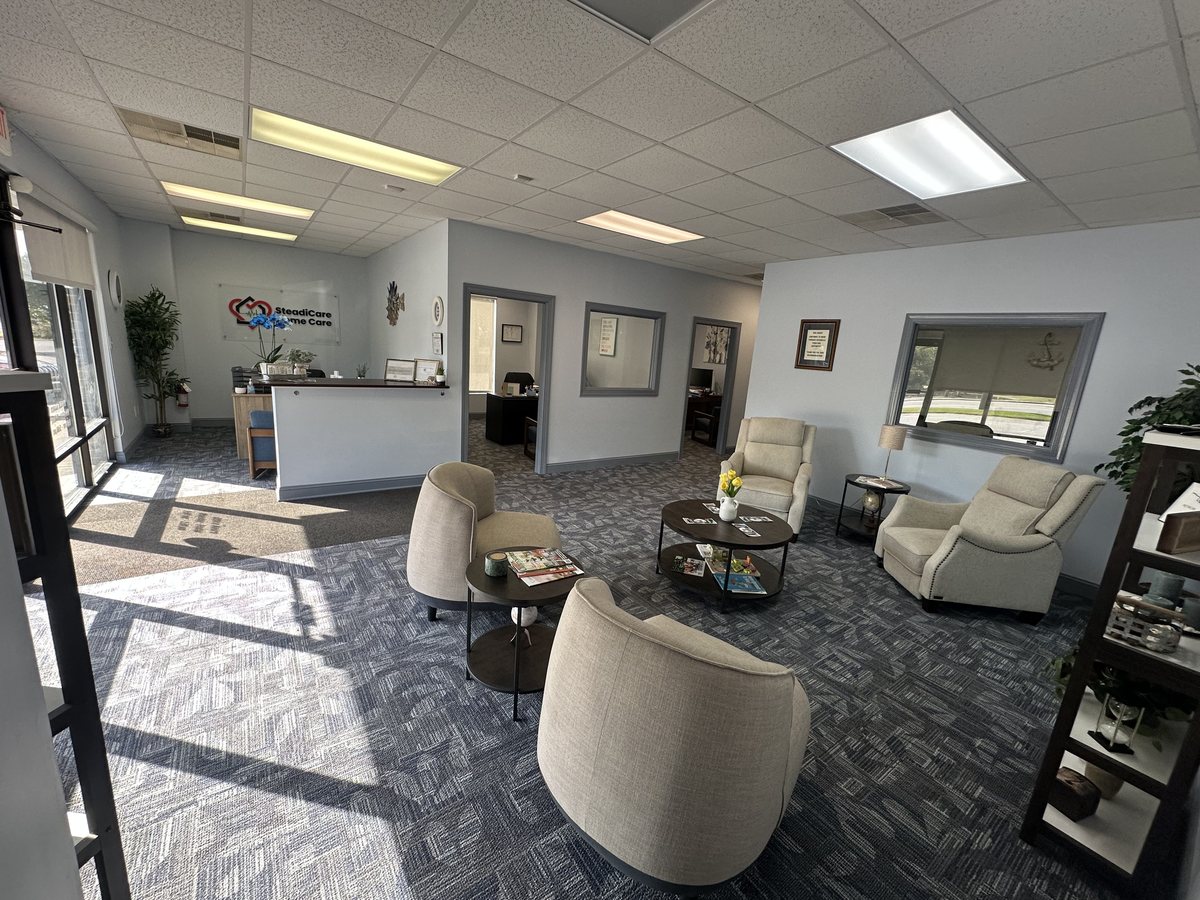 The reception lobby at SteadiCare Home Care's Greenwood office, with comfortable seating and the SteadiCare sign on the wall